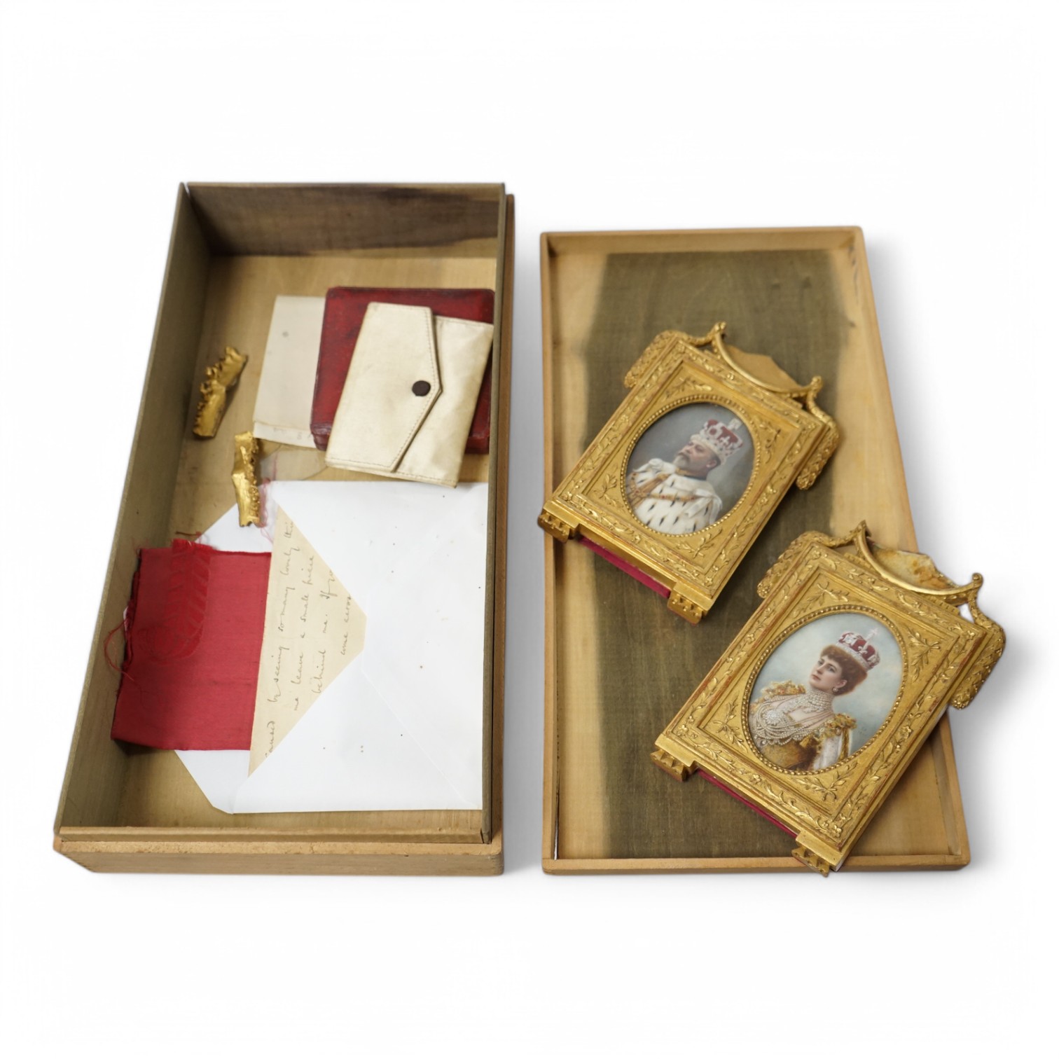 An archive including a pair of miniature portraits on ivory of Edward VII and Queen Alexandra in their coronation robes, in decorative gilt frames with Damask silk backing, 9cm high